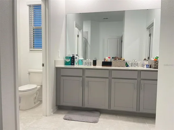 a bed sitting in a bedroom chandelier