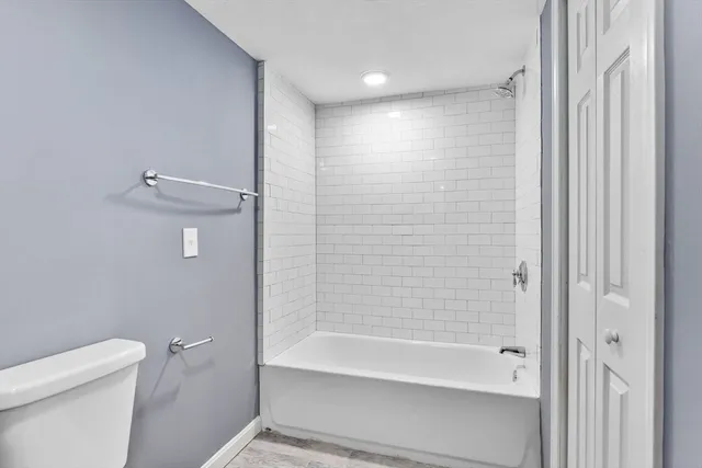 a bathroom with a bathtub and a toilet
