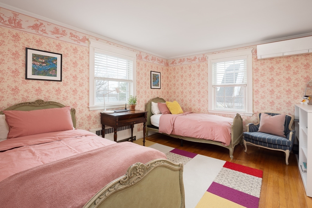 228 Wolcott Road Brookline, MA 02467 - Photo 12 of 29 a bedroom with a bed and wooden floor