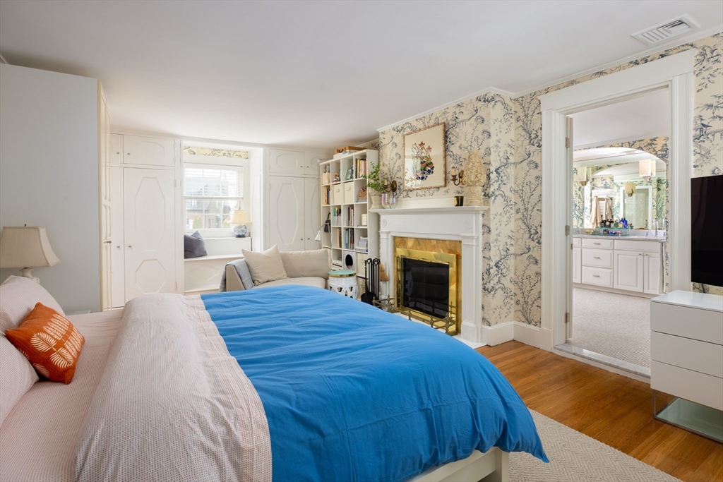 228 Wolcott Road Brookline, MA 02467 - Photo 9 of 29 a spacious bedroom with a bed and a fireplace