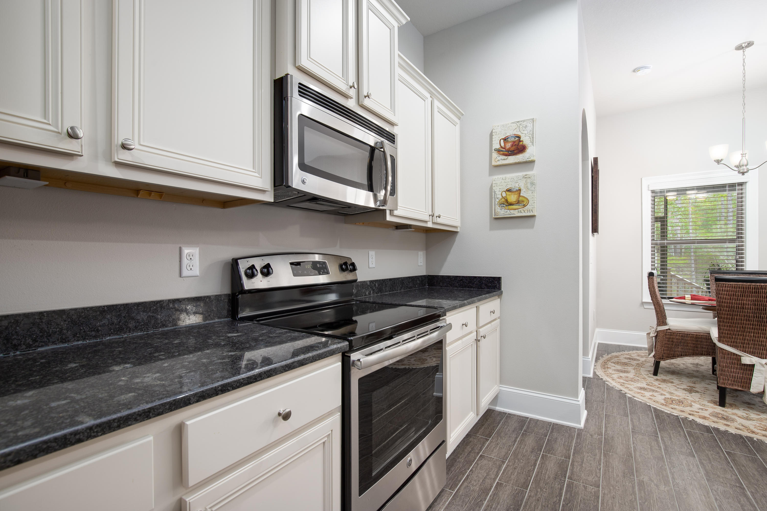 3 Buddy Lane Santa Rosa Beach, FL 32459 - Photo 5 of 21 a kitchen with stainless steel appliances granite countertop a stove a sink and a microwave