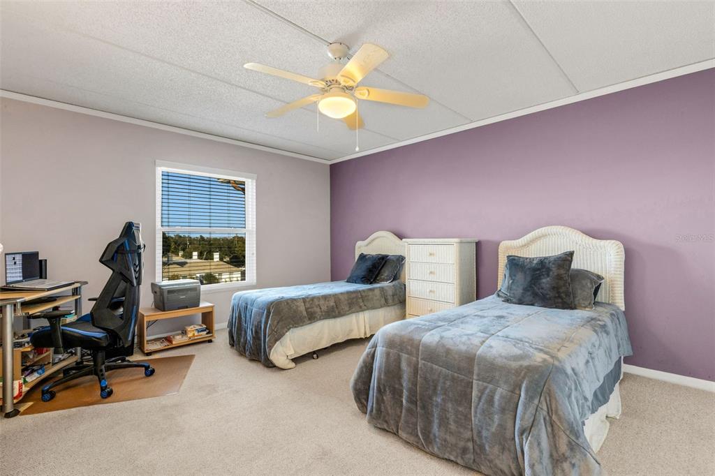 12760 Indian Rocks Road, Unit 119 Largo, FL 33774 - Photo 17 of 24 a bedroom with two beds and a chandelier