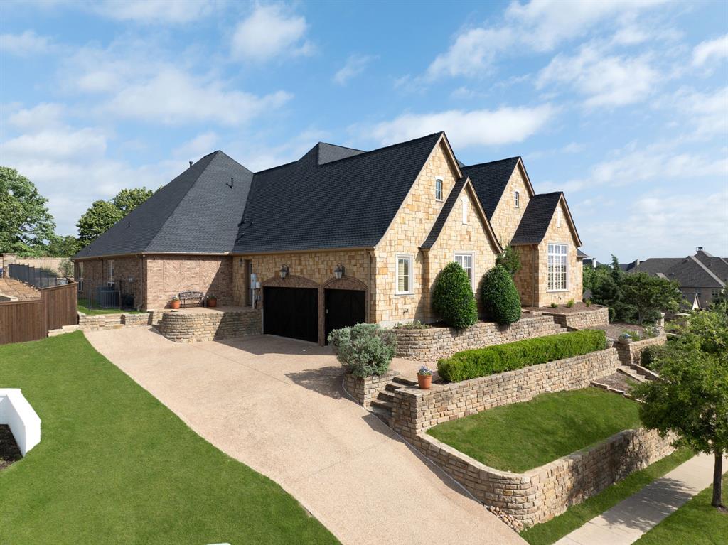 771 Hayden Road Lantana, TX 76226 - Photo 2 of 40 Mature landscaping, accent lighting, and a stone facade!