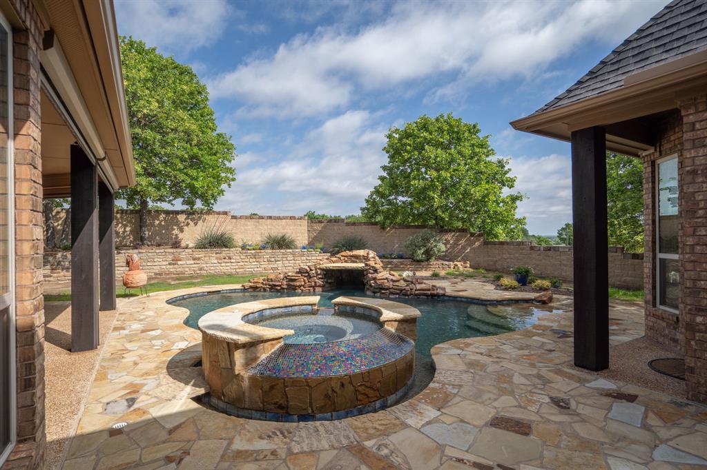 771 Hayden Road Lantana, TX 76226 - Photo 37 of 40 Backyard features a saltwater pool, spa, and waterfalls!