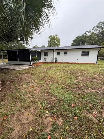 a view of a house with a backyard