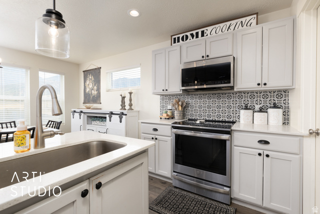 1713 South Windemere Road Santaquin, UT 84655 - Photo 11 of 40 Contemporary kitchen featuring light gray cabinetry, stainless steel appliances, and a patterned tile backsplash