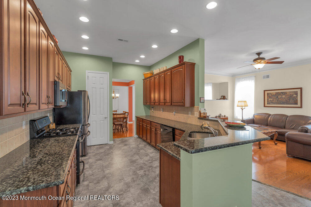 10 Crooked Stick Road Jackson, NJ 08527 - Photo 16 of 52 a kitchen with stainless steel appliances granite countertop sink stove refrigerator and cabinets