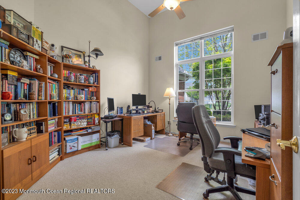 10 Crooked Stick Road Jackson, NJ 08527 - Photo 25 of 52 a view of a workspace with furniture and a bookshelf