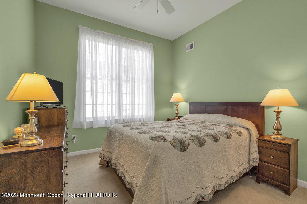 10 Crooked Stick Road Jackson, NJ 08527 - Photo 31 of 52 a bedroom with a bed and a lamp