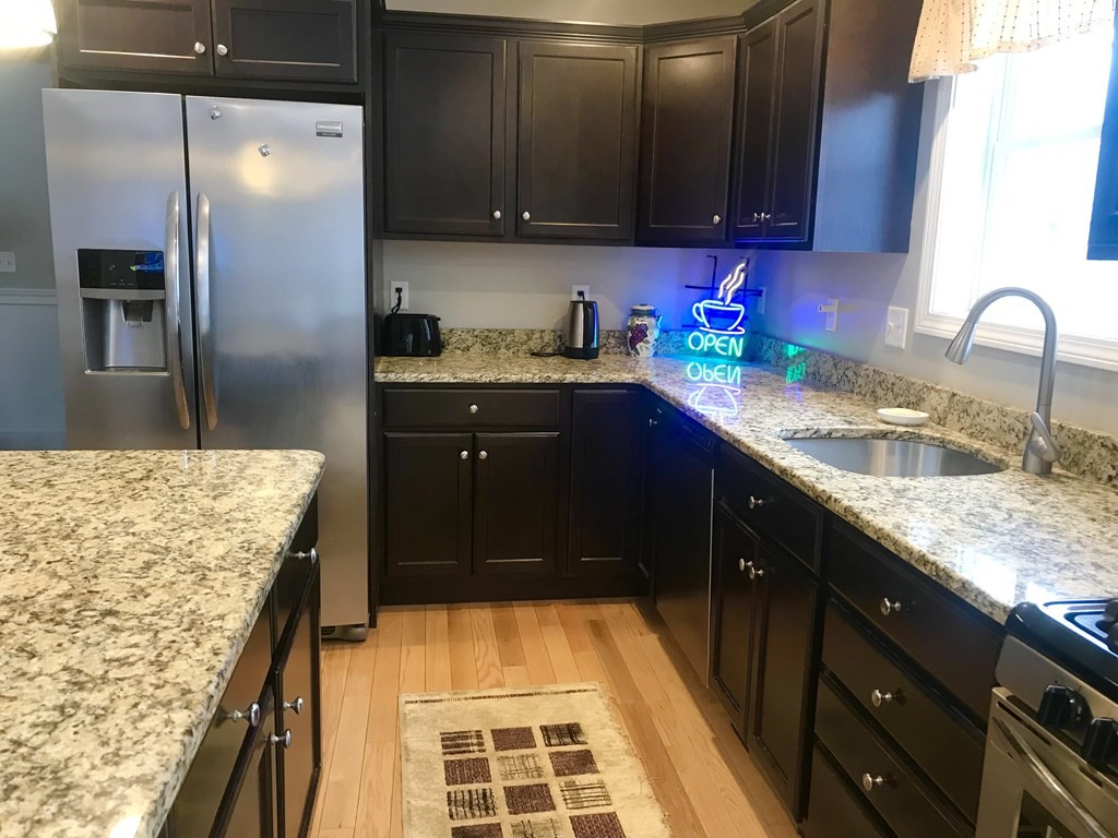 162 Fitchburg Road Townsend, MA 01469 - Photo 6 of 13 a kitchen with granite countertop stainless steel appliances and wooden cabinets