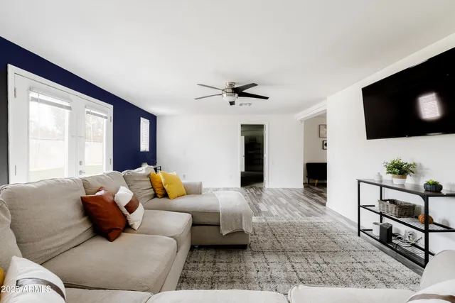 a living room with furniture and a flat screen tv