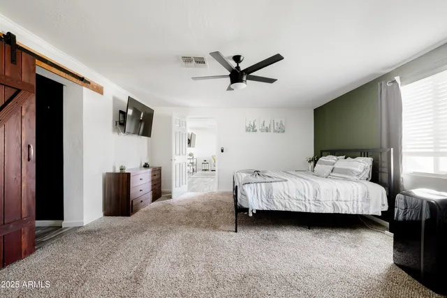 a bed room with furniture and a flat screen tv
