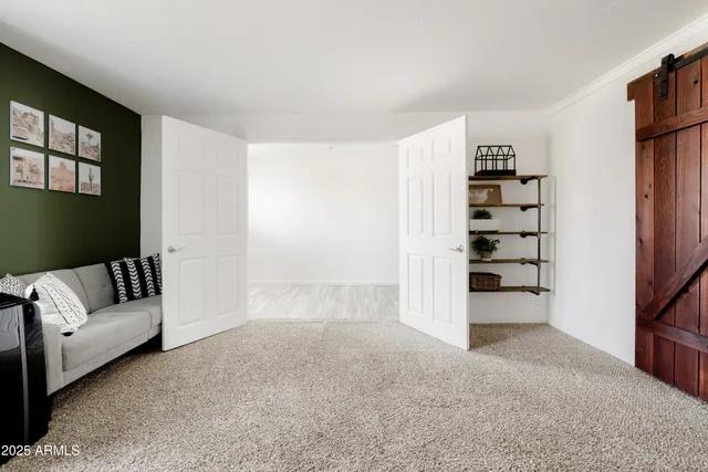 a view of a livingroom with furniture and staircase