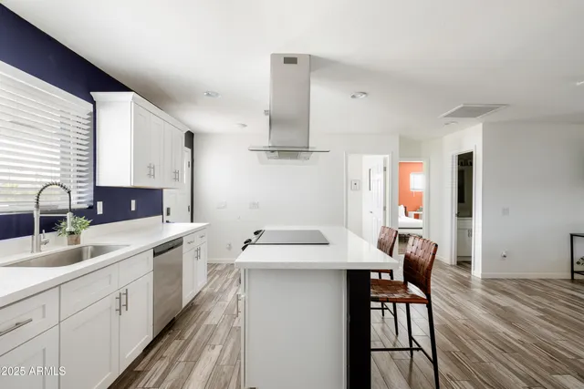 a kitchen with stainless steel appliances a sink stove and cabinets