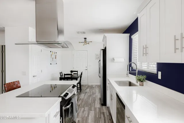 a kitchen with a sink a stove and a refrigerator