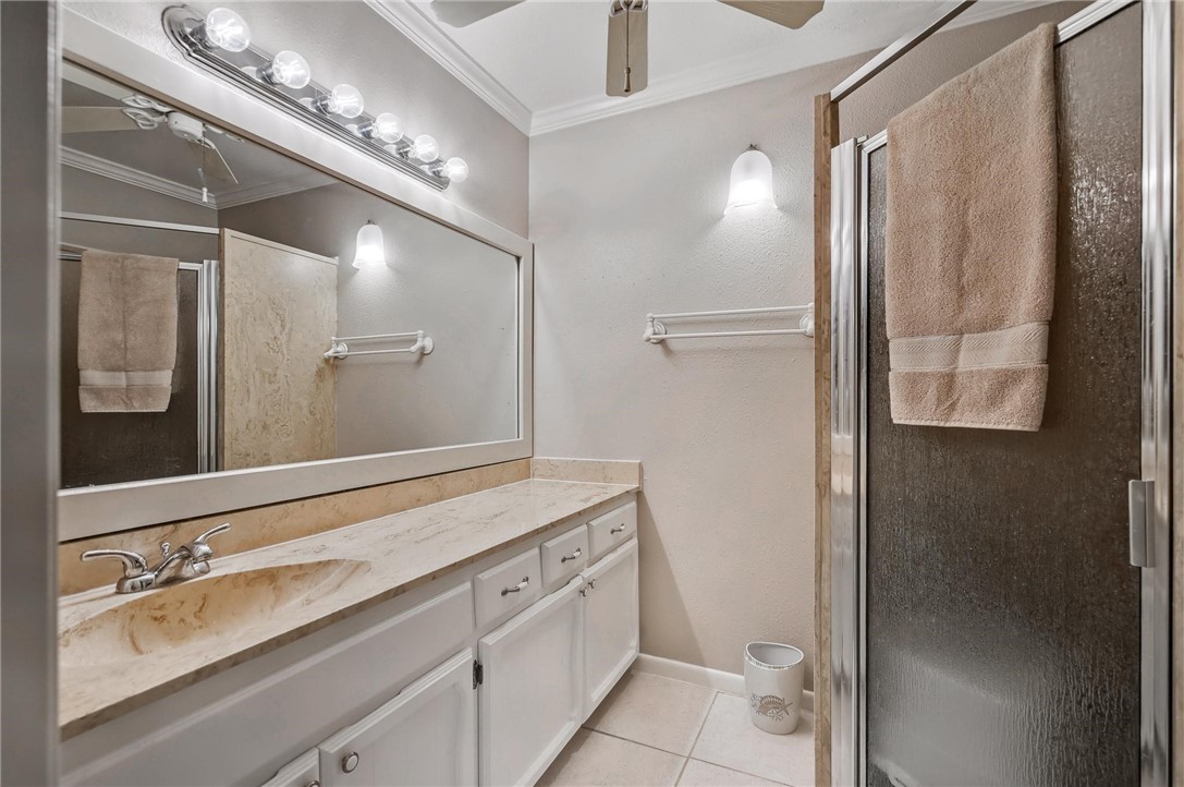 4957 Shadowbend Drive Corpus Christi, TX 78413 - Photo 7 of 35 a bathroom with a double vanity sink and a mirror
