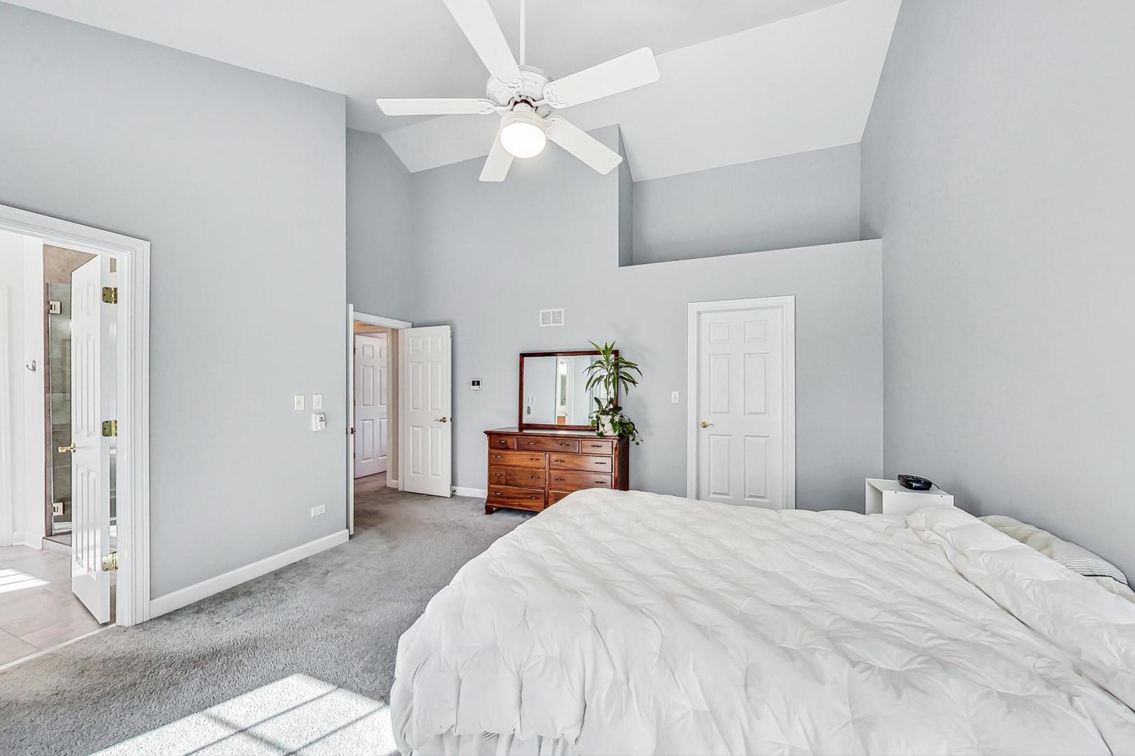 1429 Castleton Road Libertyville, IL 60048 - Photo 17 of 30 a bedroom with a large bed and a chandelier