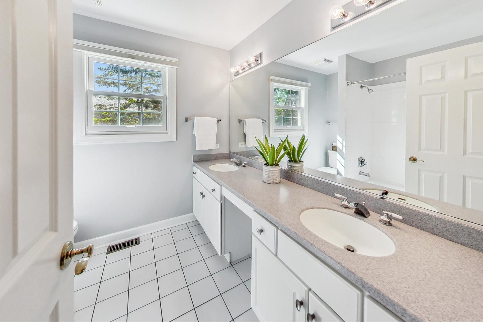 1429 Castleton Road Libertyville, IL 60048 - Photo 22 of 30 a spacious bathroom with a double vanity sink mirror and a window