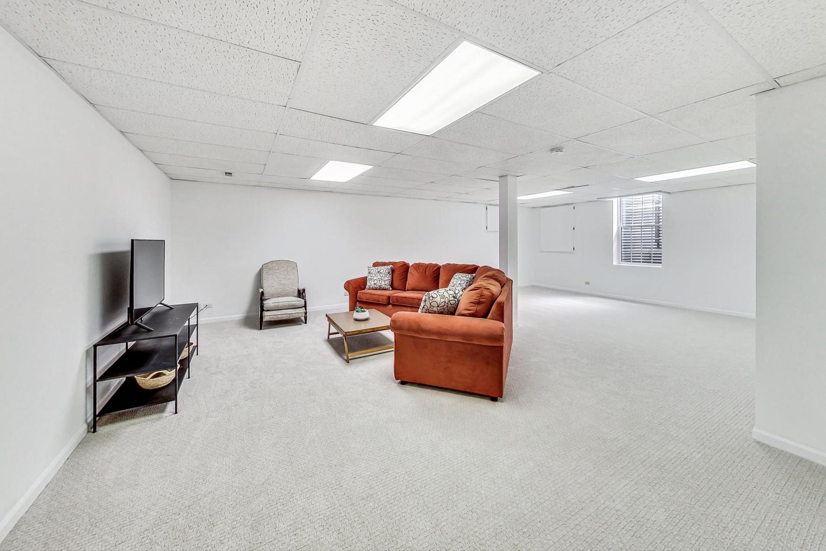 1429 Castleton Road Libertyville, IL 60048 - Photo 23 of 30 a living room with furniture and a flat screen tv