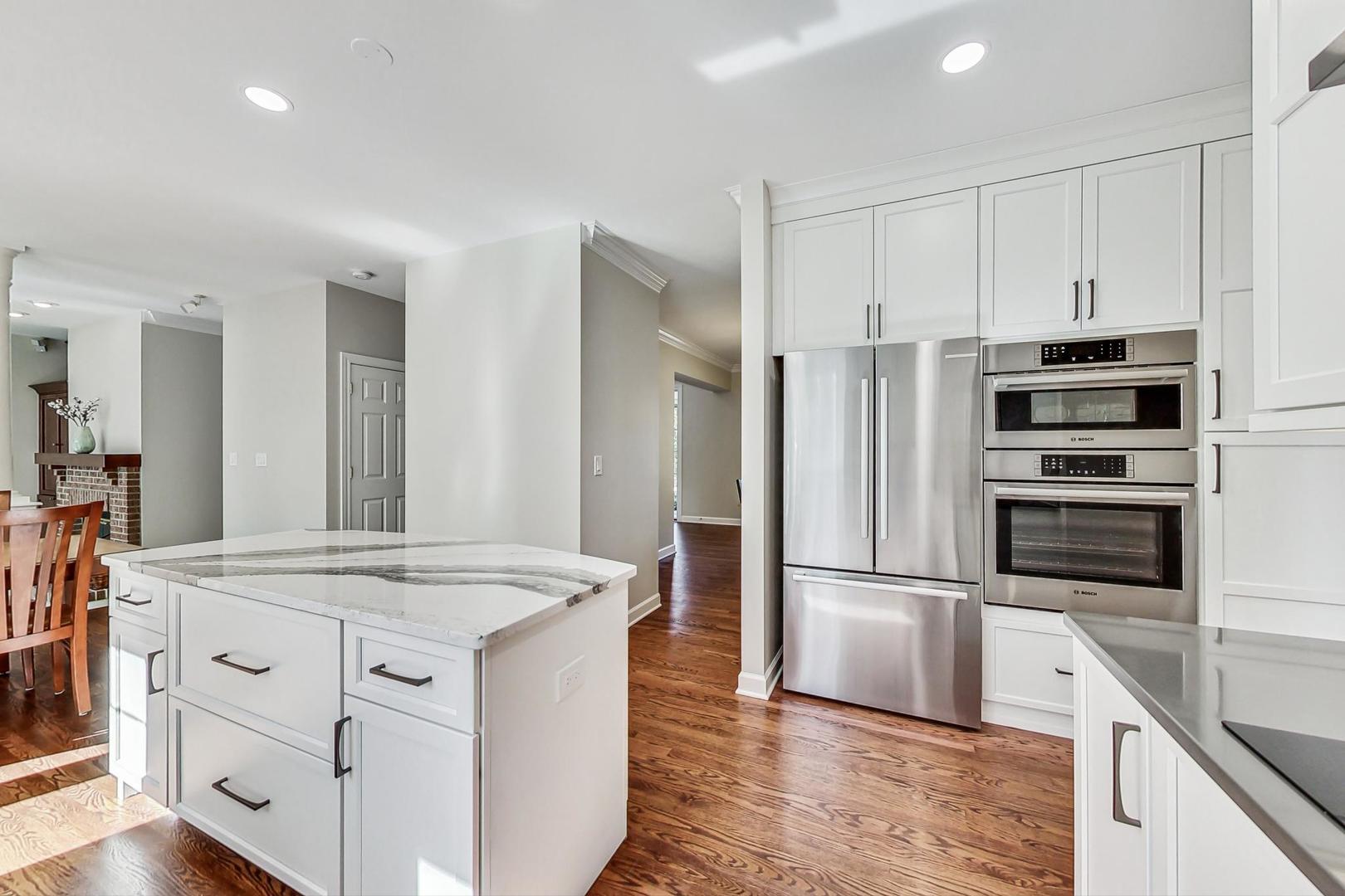 1429 Castleton Road Libertyville, IL 60048 - Photo 9 of 30 a kitchen with kitchen island white cabinets and stainless steel appliances