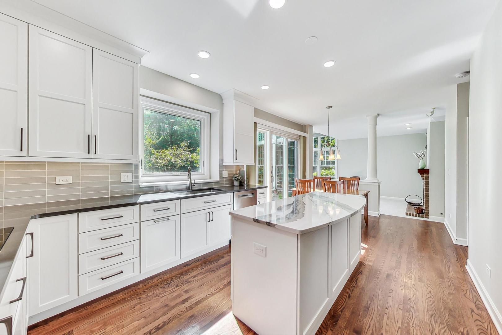 1429 Castleton Road Libertyville, IL 60048 - Photo 10 of 30 a large kitchen with stainless steel appliances granite countertop a sink and dishwasher with wooden floor