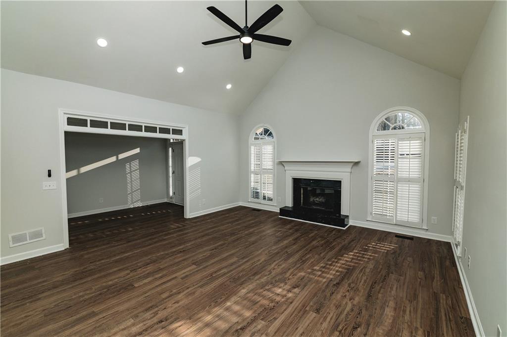 525 Rams Way Tucker, GA 30084 - Photo 13 of 41 a view of an empty room with wooden floor fireplace and a window