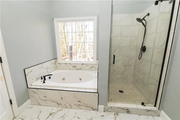 a bathroom with a bathtub and shower