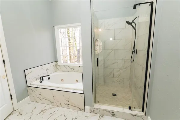 a bathroom with a bathtub and a shower