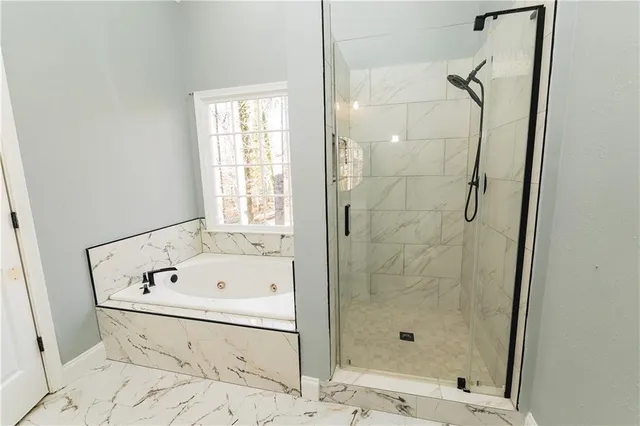 a bathroom with a bathtub and a shower
