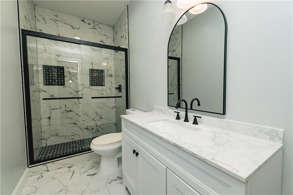 525 Rams Way Tucker, GA 30084 - Photo 31 of 41 a bathroom with a sink a toilet and shower