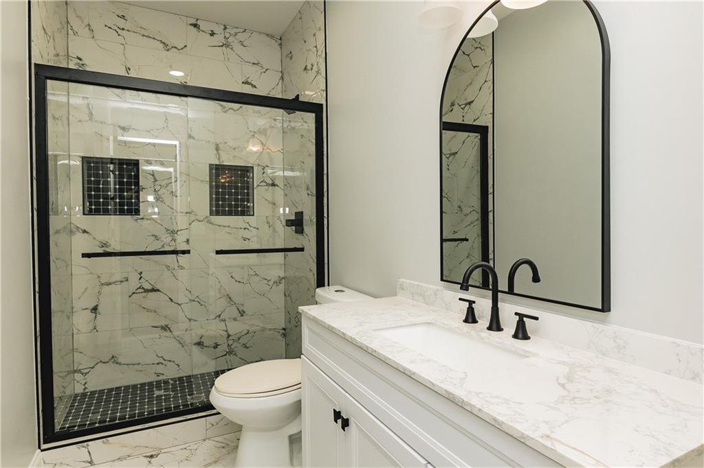 525 Rams Way Tucker, GA 30084 - Photo 32 of 41 a bathroom with a sink a toilet and shower