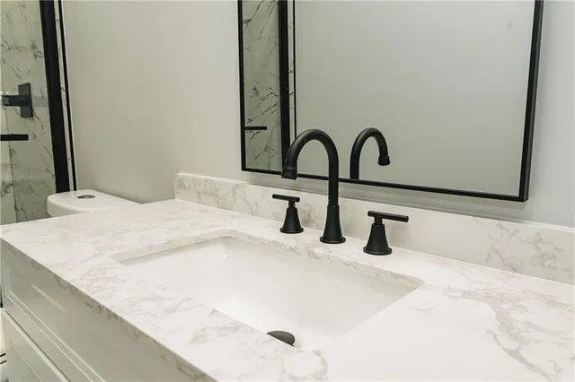 a bathroom with a sink and a bed