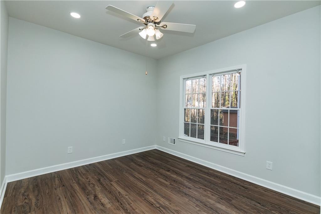 525 Rams Way Tucker, GA 30084 - Photo 37 of 41 an empty room with wooden floor and windows