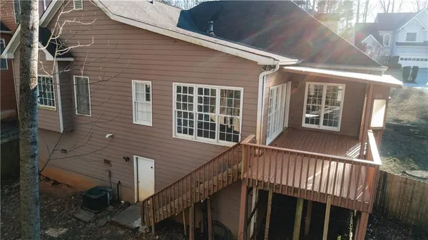 a view of a house with wooden fence and two windows