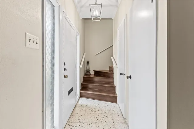 a view of entryway and hall with wooden floor