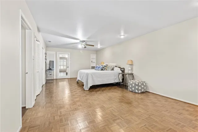 a spacious bedroom with a bed and a cabinets