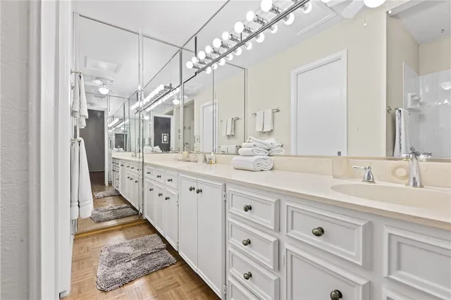 a bathroom with double vanity sink and a mirror