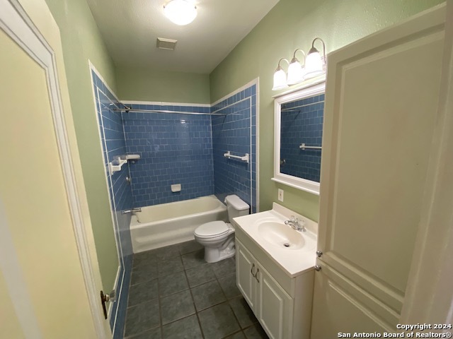 323 Carleton Court, Unit 4 San Antonio, TX 78212 - Photo 6 of 12 a bathroom with a sink a toilet and shower