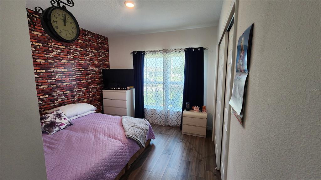 4540 Lake Russell Road Kissimmee, FL 34746 - Photo 18 of 35 a bedroom with a bed and a mirror