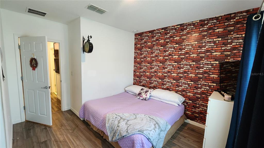 4540 Lake Russell Road Kissimmee, FL 34746 - Photo 19 of 35 a bedroom with a bed and a wooden floor