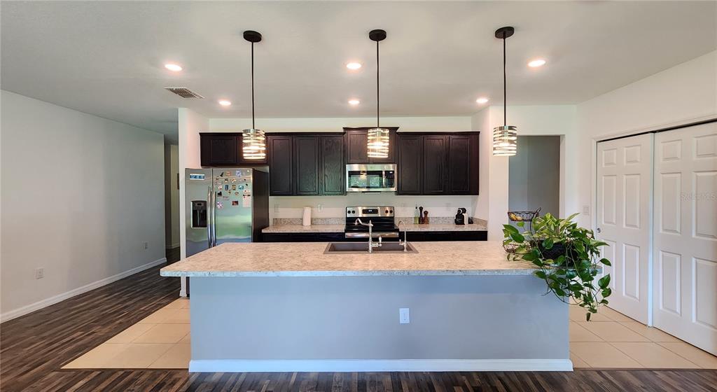 4540 Lake Russell Road Kissimmee, FL 34746 - Photo 22 of 35 a room with kitchen island a potted plant a sink and a potted plant