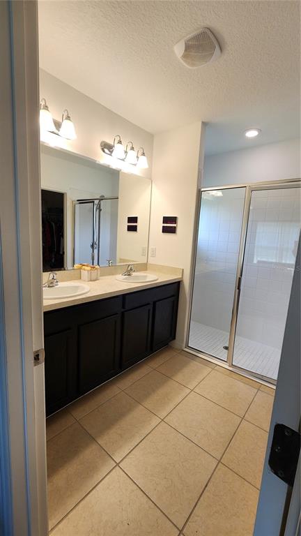 4540 Lake Russell Road Kissimmee, FL 34746 - Photo 31 of 35 a bathroom with a sink a mirror and a shower