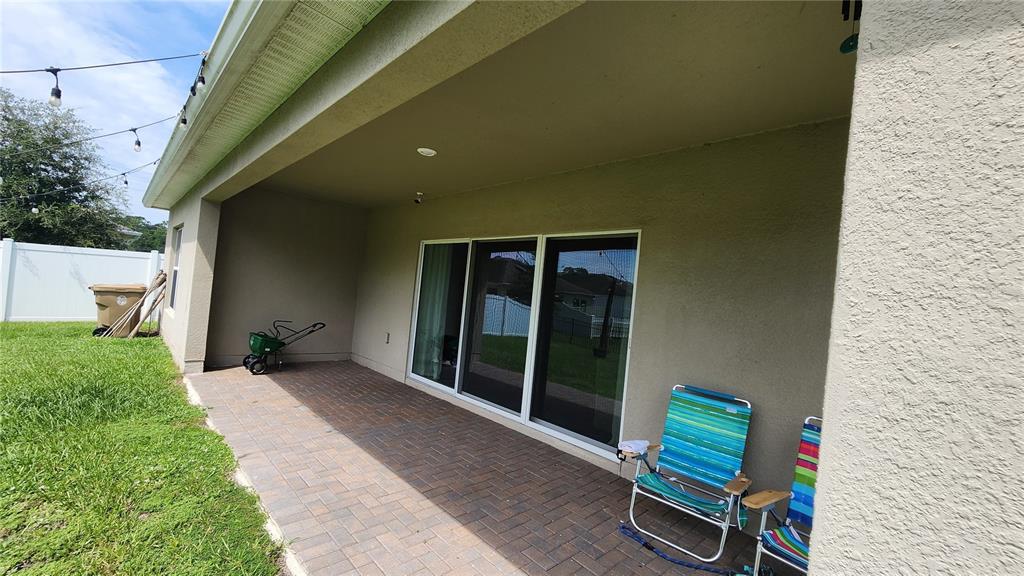 4540 Lake Russell Road Kissimmee, FL 34746 - Photo 34 of 35 a backyard of a house with table and chairs