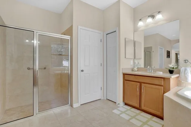 a bathroom with a shower sink and mirror