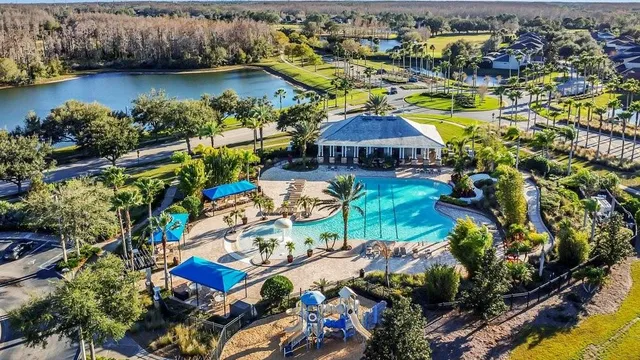 an aerial view of a house with a garden and lake view