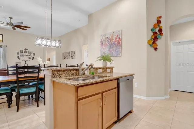 a dining hall with a sink and a refrigerator