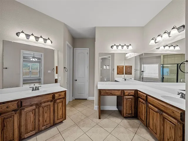 a bathroom with a tub sink and mirror