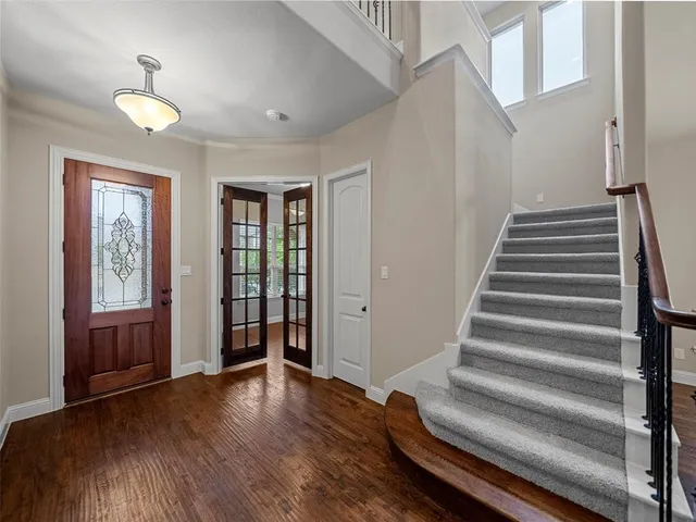 a view of entryway with wooden floor and stairs