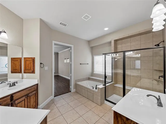 a view of a kitchen with granite countertop lots of wooden cabinets