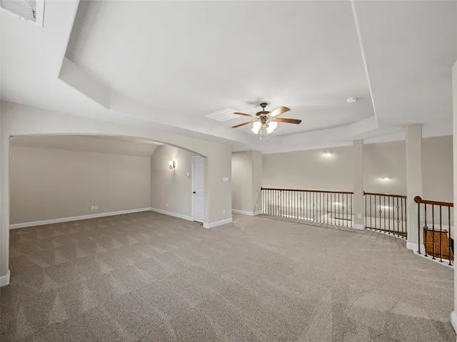 a view of an empty room with a kitchen